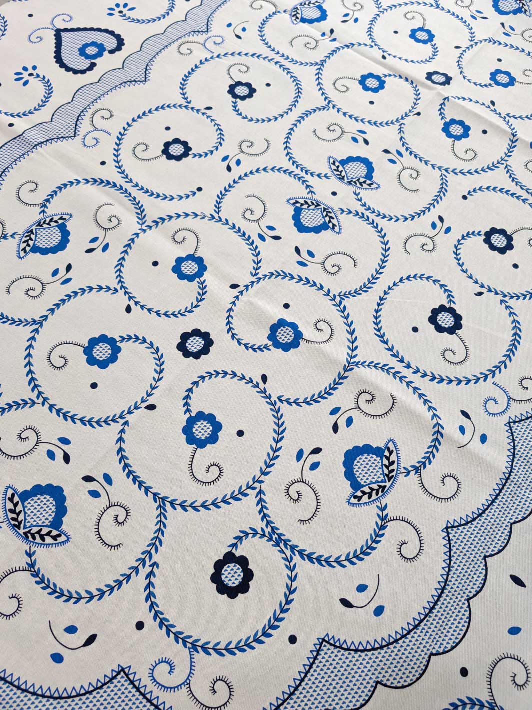 Close-up of a blue and black floral pattern on a white background