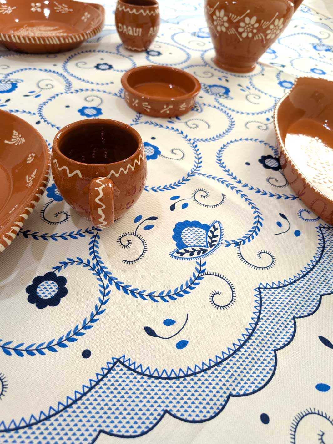 Clay pots on a tablecloth with blue patterns