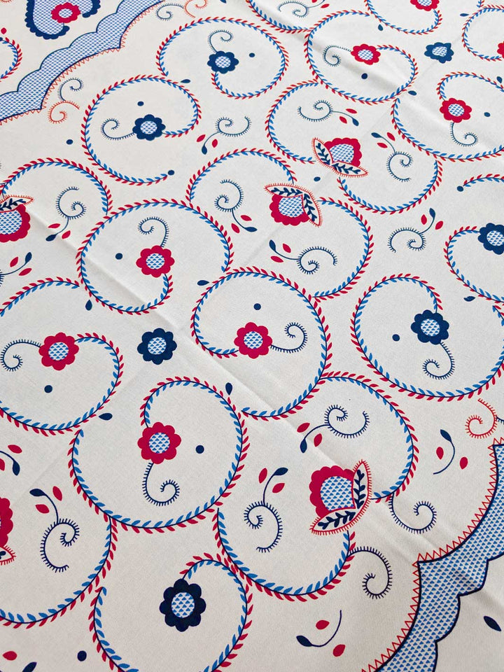 Close-up of a fabric with intricate patterns and colors on a white background