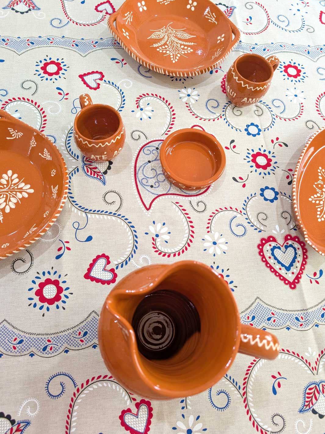 Ceramic dishes on a tablecloth with decorative patterns