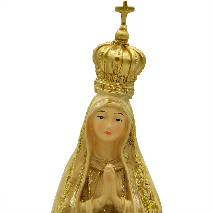 This Our Lady of Fatima statue is made in Fatima, Portugal by the hands of the same artisans that craft the statues of the Shrine of Fatima. The impressive craftsmanship and attention to detail give it a wooden look-alike appearance, although it's made from resin. The figurine sits on a cloud and shows Our Lady wearing a mantle with golden accents painted by hand. On the bottom of the statue it has a music box operated by batteries that plays the Fátima Hymn, Ave.