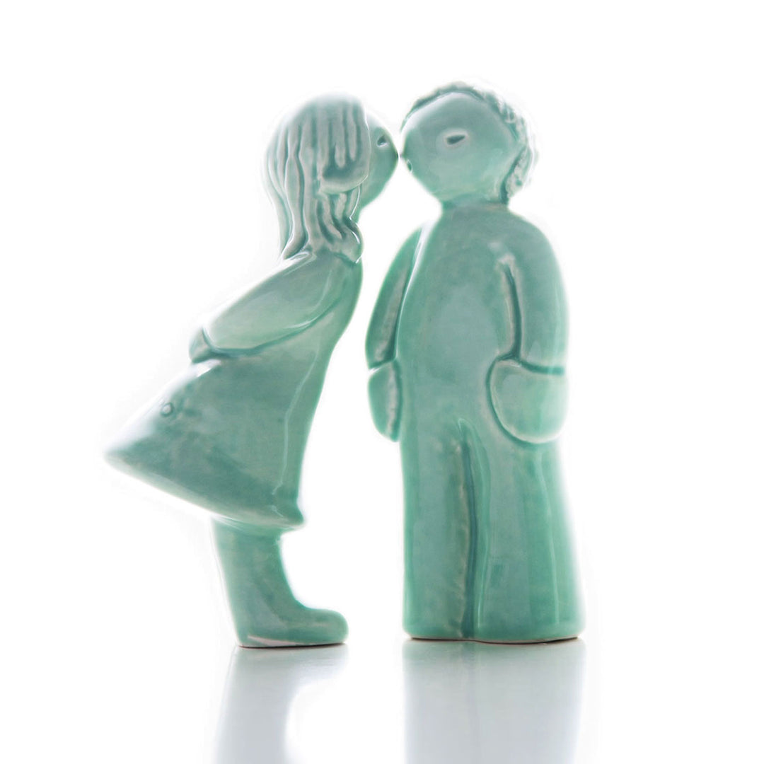 These precious handmade ceramic collectible figurines are the perfect way of telling someone how much you care. The set is composed by 2 figurines: a girl giving a kiss, and the boy who receives it, creating a unique decorative ornament for your home to display on a shelf, coffee table or mantel.