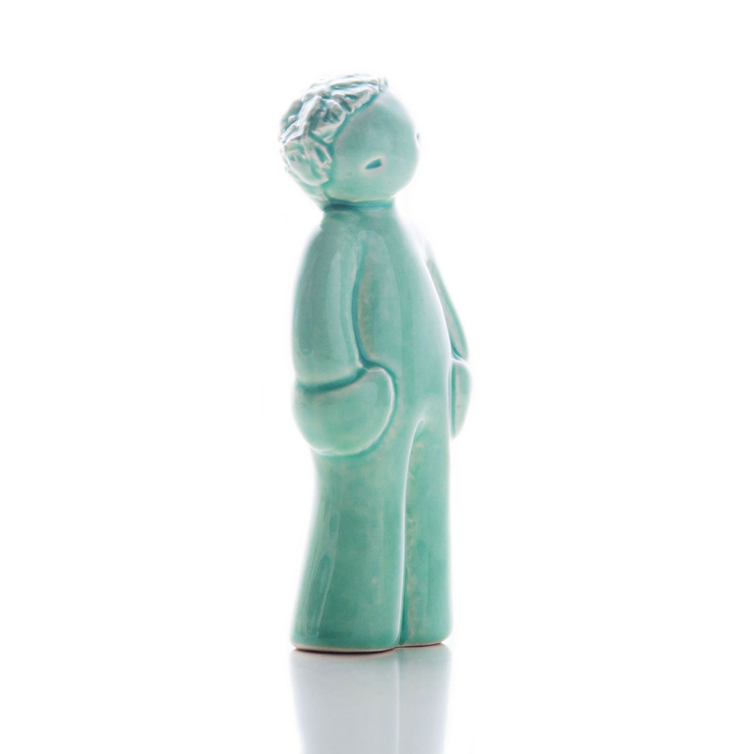 Handmade portuguese ceramic figurine of a boy receiving a kiss.
